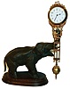 Junghans, Germany,  "Elephant" model swinger, 8 day novelty timepiece, the patinated spelter elephant mounted to a molded beech wood base, his trunk supporting the gilt and patinated clock case/ pendulum, white enamel Arabic numeral dial with junghans logo, blued steel hands, 8 day time only movement, signed "Junghans Germany",ca.1920