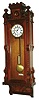 Eastlake American Wall Clock, attributed to Herter Brothers, New York, 8 days, time only, weight driven Vienna regulator movement with white enamel dial and seconds bit in an extra deep walnut and burled walnut case with carved rosettes, engravings and turned urn finials, c1880