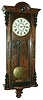 New Haven Clock Co., New Haven, Conn., for T. Turton, Northampton (England) stained wood 8 day time and strike wall clock, c1890