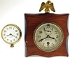 Clocks- 2 (Two): a Chelsea timepiece with 2 3/4" dial, signed "Jos. W. Jones, New York, U.S.A.", and mounted to a wooden plaque with eagle finial, and a Waltham 8 day travel clock with enamel dial, serial #22871188
