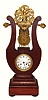 French, lyre form mantel clock, the case of mahogany, and the pendulum suspended above the movement, behind the lyre "strings", c1840