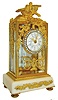 France, desk or table clock, case with gilt brass frame set with beveled glasses, rear door with plain glass, the top with gilt birds, case front and sides with bowknot suspended floral garlands, classically inspired scrolled foliate element below dial, on a white marble base with inset grape and leaf ornament, on beaded toupie feet, brilliant set bezel with convex beveled glass, Roman numeral white enamel dial with Arabic black outer 5 minute markers, and with polychrome floral swag decoration, gilt Louis XV style hands, small 8 day time only movement with cylinder platform, c1910