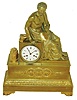 France, large gilt bronze mantel clock, seated male figure with scrolls and laurel wreath above an acanthus molded base on Grecian scrolled feet, front with interlocking wreaths, two of which contain lightning, and with a spear behind, beaded bezel with beveled glass, Roman numeral white enamel dial with blued steel hands, 8 day time and count wheel strike pendule a Paris movement signed "Pons", pendulum with silk thread suspension, case back also with glazed bezel, c1840