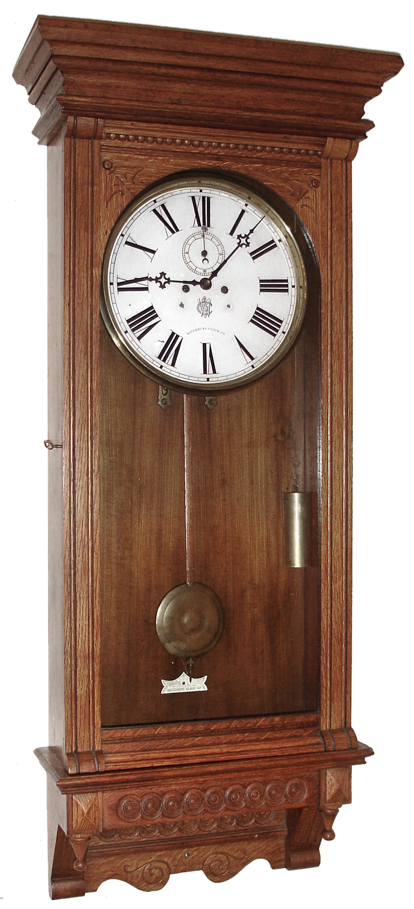Waterbury Clock Co., Waterbury, Conn., "Regulator No. 54" wall clock, 8 day, time only, two weight driven movement in an oak case with embossed lower trim and painted metal dial, c1906 — Antique Clocks Price Guide