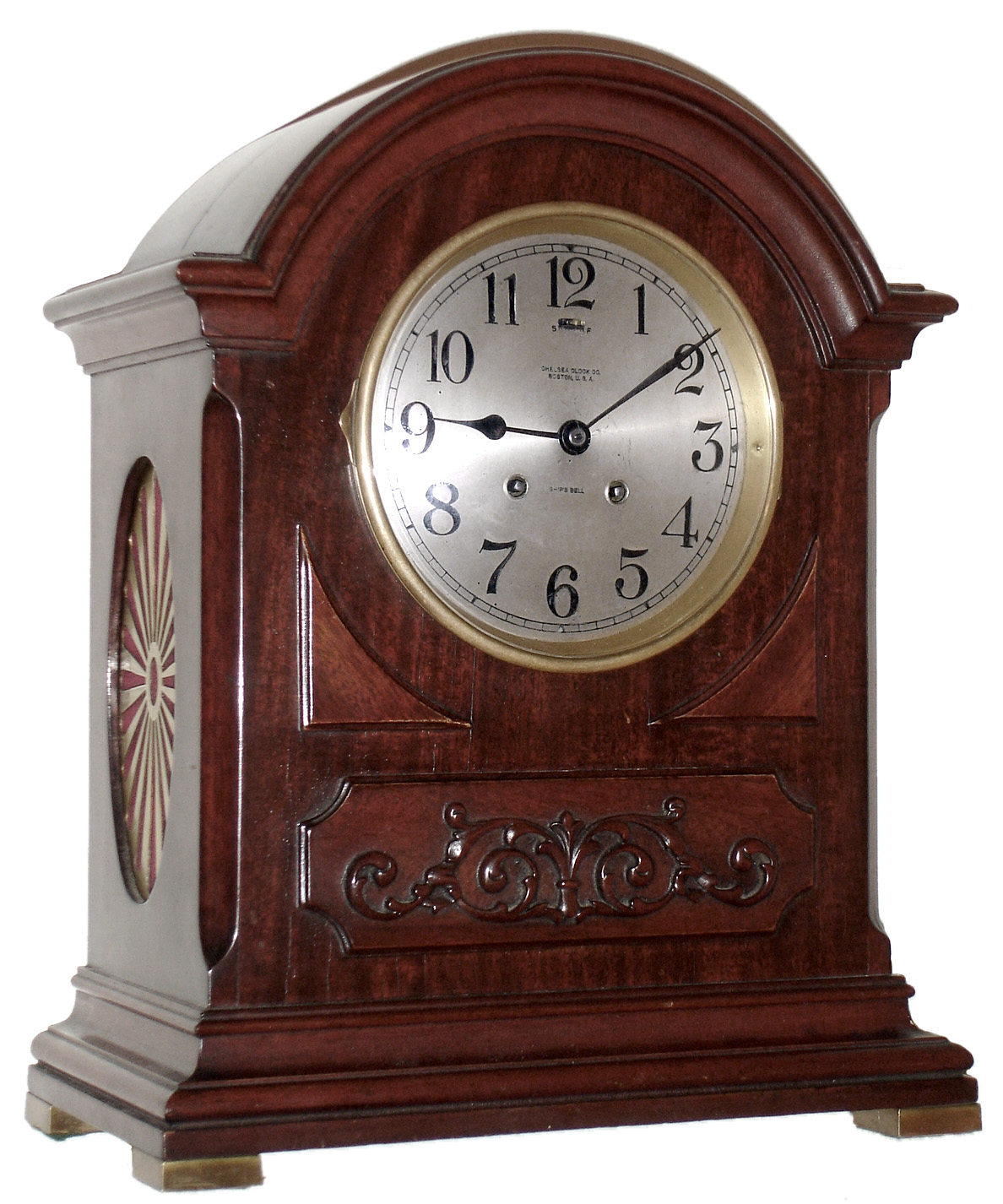 Chelsea Clock Co., Boston, Mass., "Mahogany Dome" mantel clock, 8 day, time and ship's bell strike, spring driven movement with lever escapement in a mahogany case with applied carving below dial and fret work sides set on square brass feet and 6" silvered metal dial, c1920 s#136079 — Antique Clocks Price Guide