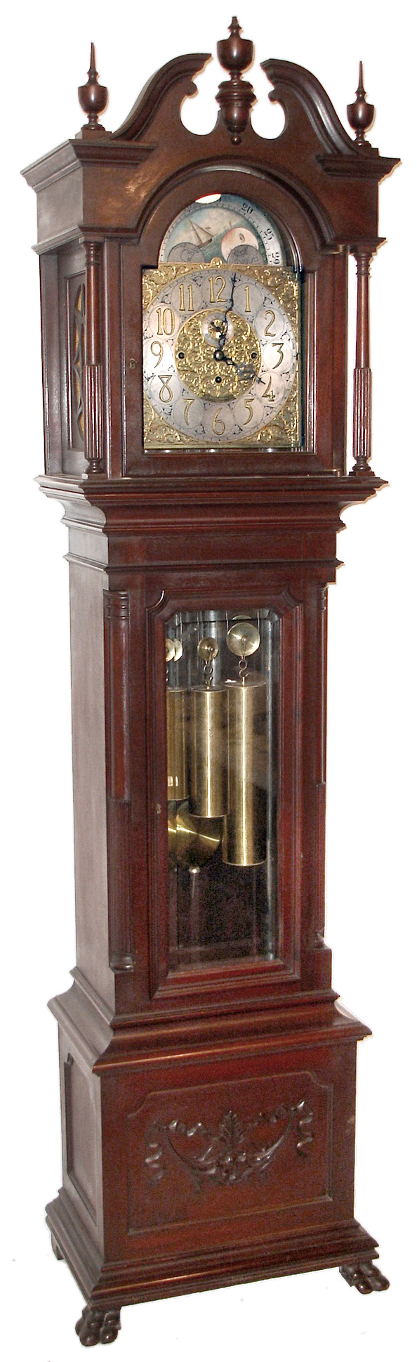 Herschede Clock Co., Cincinnati, Ohio, "Tubular Chime Tall Clock Pattern No. 5", 8 day, moon phase, time, strike and chime, weight driven J.J. Elliot Ltd., London movement Westminster chiming on five signed Walter Durfee patented tubes in a mahogany case with applied carvings to base, paw feet, beveled glass trunk door, reeded and smooth quarter columns on trunk conforming with reeded and smooth full columns flanking hood door and broken arch pediment top. The brass dial has an applied silvered chapter ring with raised brass Arabic numerals, intricately cut and engraved corner spandrels and dial center and painted moon phase disc, c1900 — Antique Clocks Price Guide