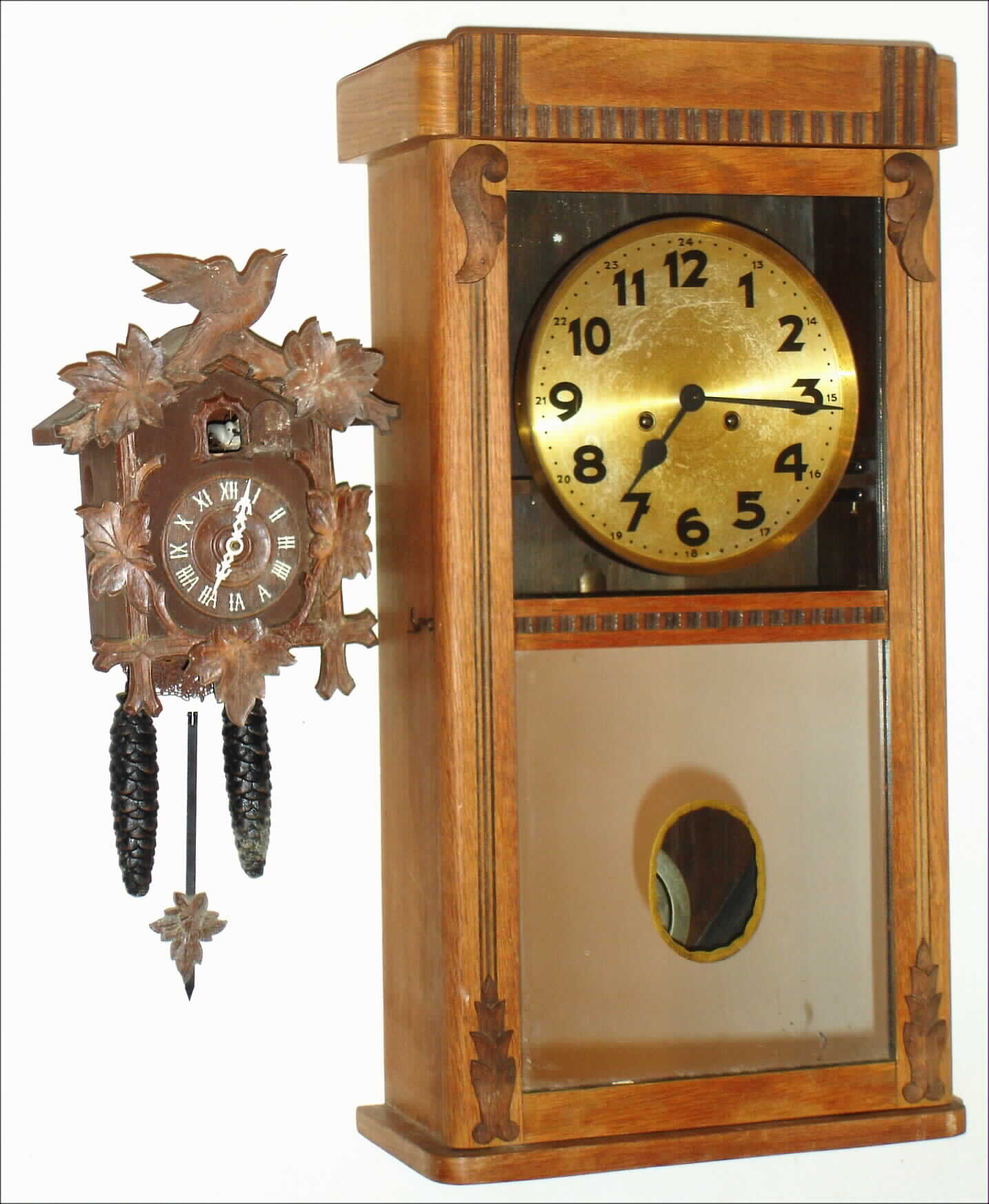 Clocks- 2 (Two) wood wall clocks: German 8 day, time and strike box regulator; Lux Waterbury Conn. 30 hour cuckoo; early 20th century — Antique Clocks Price Guide