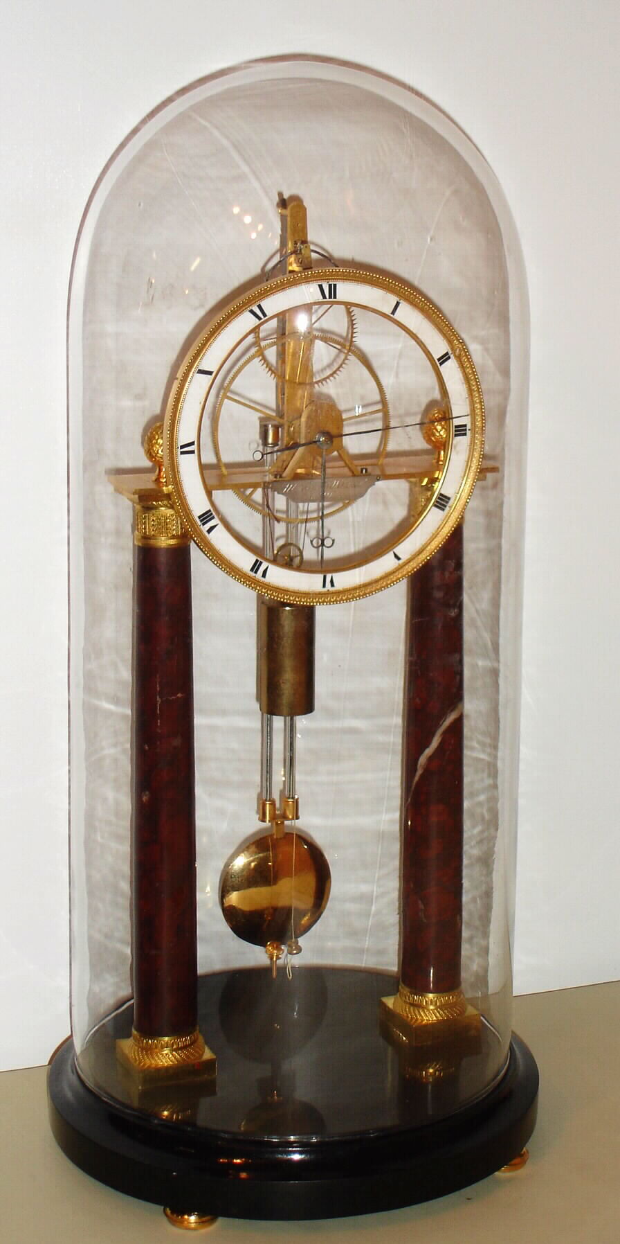 Austrian, Mathias Wibral [in Wien], a weight driven, pull wind, 2-wheel Empire era skeleton clock, with mercurial compensating pendulum, first qtr of 19th Century, with glass dome, one day duration. — Antique Clocks Price Guide