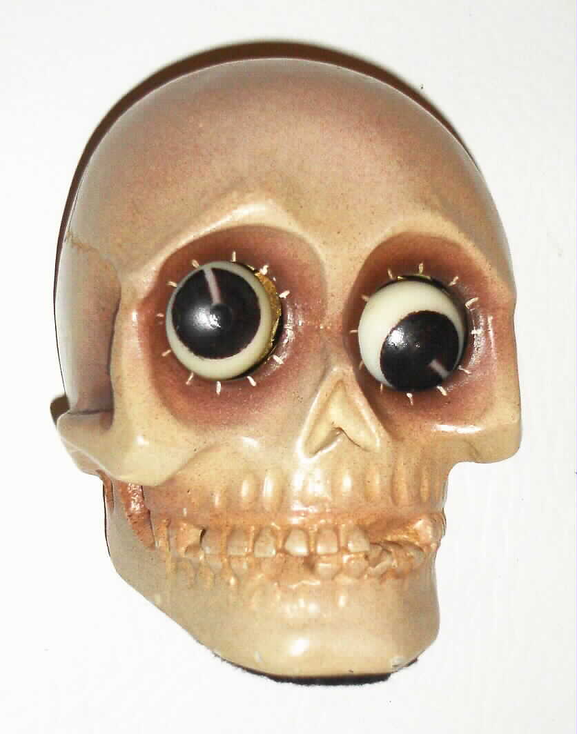Oswald Uhrenfabrik, Germany, "Skull" rotating eye time piece, 30 hour, time only, spring driven movement in a composition case with grey skull and brown eyes, c1930 — Antique Clocks Price Guide