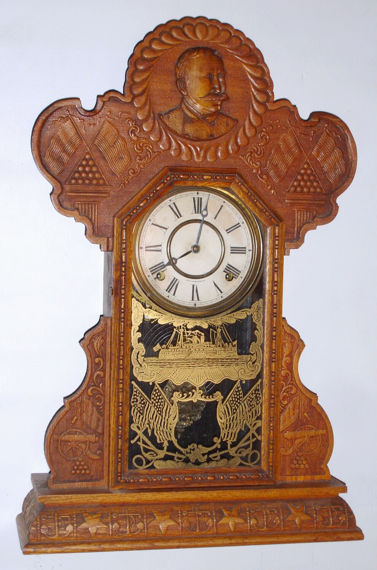 E. Ingraham, Bristol, Conn. "Admiral Dewey" oak 8 day, time and strike gingerbread clock, c1899 — Antique Clocks Price Guide