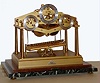 Dent, London, England, "Congreve Rolling Ball Clock", 8 day, spring driven, fusee movement with maintaining power is regulated by a rolling steel ball traversing an inclined plane every 15 seconds, tripping a lever, tilting the plane in the opposite direction, while registering 15 second intervals on the right dial, minutes on the center and hours on the left all on a marble base in a Plexiglas case, dated 1973
