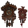 Clocks- 2 (Two) German carved wood two weight 30 hour cuckoos: one early 20th century American Cuckoo Clock Co.; one modern Kuner with Regula works. Larger case ht 16"