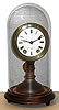 Seth Thomas Sons and Co., Thomaston, Conn., "No. 5002" or candlestick mantel clock, 8 day, time and bell strike, spring driven movement with porcelain dial. wooden turned candlestick style base and glass dome, c1875
