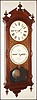 Ithaca Calendar Clock Co., Ithaca, New York "No. 2 Bank" double dial calendar regulator wall clock, 8 day, time only, two weight driven movement in a walnut case with engraved mask around paper over zinc dials, c1880