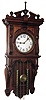 Waterbury Clock Co., Waterbury, Conn., "Alabama" wall clock, 8 day, time and strike, two weight driven movement in an oak case with white enamel dial and brass hands and twisted weights, c1905