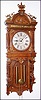 Waterbury Clock Co., Waterbury, Conn., "Augusta" wall clock, 8 day, time and strike, two weight driven movement in an oak case with cast brass ornaments and silvered metal dial, c1893