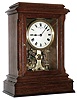Eureka Clock Co, Ltd, London, England battery powered mantel clock with oversized balance wheel movement in an oak case with beveled glasses and cream enamel dial, c1910 s#7085