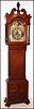 Walter Durfee, Providence, Rhode Island, "Tall Case" clock, 8 day, time, strike moon phase and calendar, weight driven movement in a mahogany case with four rope twisted columns on hood and large ornately carved finial, string brass inlay on door and trunk flanked by fluted columns on trunk over a base with four recessed panels and stylized shoe feet. The silvered brass dial has raised plaque with Durfee signature, four cast brass spandrels, raised Roman numeral chapter ring and engraved floral dial center, c1880
