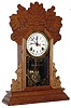 Waterbury Clock Co., Waterbury, Conn., "Niles" oak 8 day , time and strike,/calendar gingerbread clock, c1885
