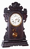 Waterbury Clock Co., Waterbury, Conn., "Rochester" walnut 8 day, time, strike and calendar oversize gingerbread clock, c1908