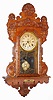 Waterbury Clock Co., Waterbury, Conn., oak hanging gingerbread, 8 day, time and strike calendar clock, c1900