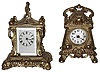 Clocks- 2 (Two) Waterbury Clock Co. gold plated fancy cast-metal carriage clocks: "Truant" 30 hour alarm; "Herald" 8 day, time, strike and repeat; c1905