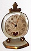 Fleus de Lys de Paris Swiss 30 hour miniature alabaster and brass beating heart time piece with original case, c1920