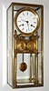 French skeleton clock, the c. 1820 spring powered time and strike movement with silk thread suspension, heavy molded brass bezel and white enamel dial, blued steel Breguet style hands, mounted to a later stand with calendar, bearing a spurious signature, covered with a purpose made, glazed rectangular dome with brass frame.