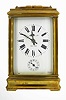 Tiffany and Co., New York, French grand sonnerie repeating carriage clock, spring powered eight day time, strike and alarm movement, with silvered platform lever escapement, sounding the hours and quarters on gongs, polished brass Cannelee variant case, beveled glass sides with oval beveled glass in top for viewing escapement, white enamel dial with Roman numeral Cannelee and Arabic alarm, signed Tiffany and Co., New York, France in lower right corner, blued steel hands, with original leather covered travelling case, c1900