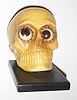 Oswald Uhrenfabrik, Germany, "Skull" rotating eye time piece, 30 hour, time only, spring driven movement in a composition case with yellow skull and brown eyes, c1930