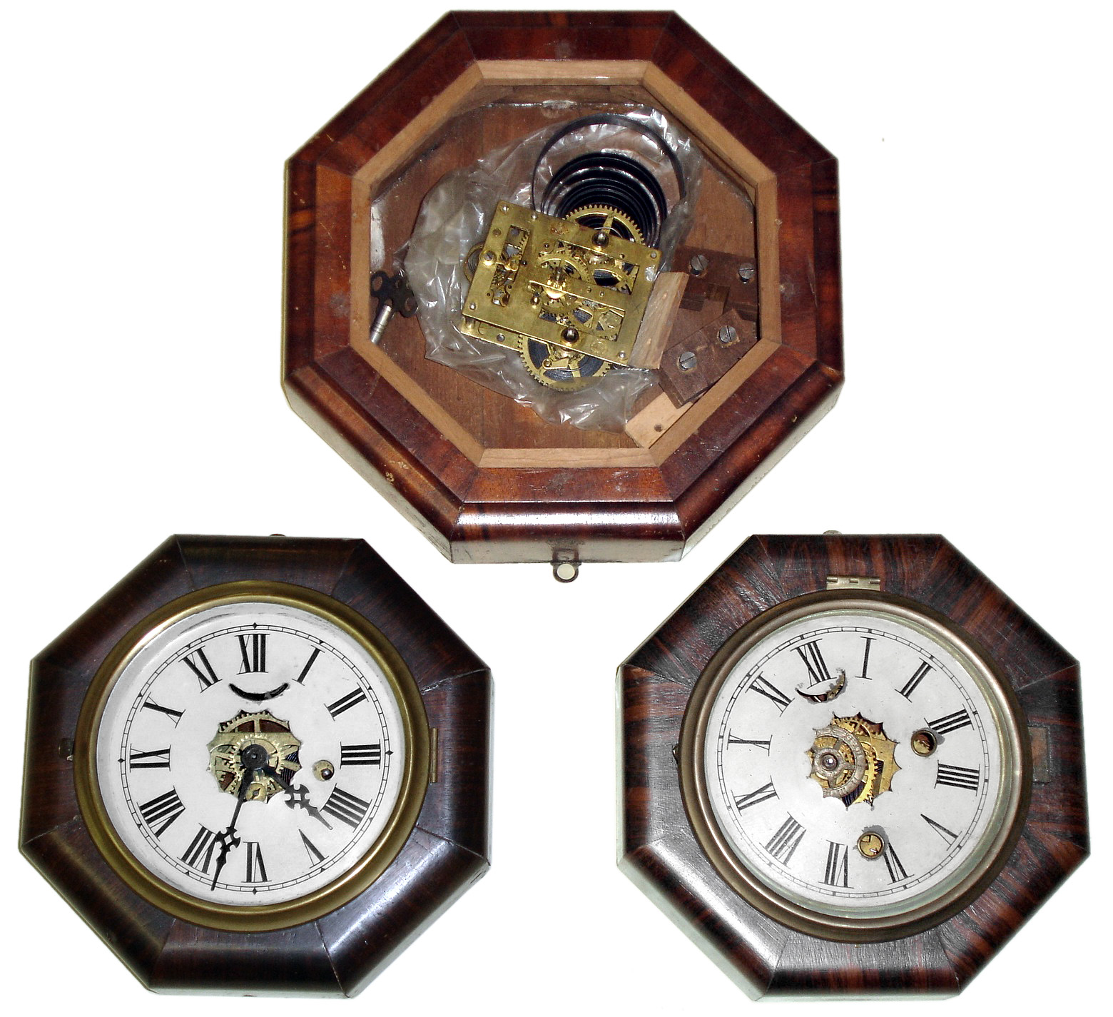 Clocks- 3 (Three) rosewood veneer, octagon Connecticut marine clocks, 2-30 hour and 1- 8-day: Welch, time and strike, and Ansonia timepiece with 5" dials; New Haven, time and strike, missing its 7" dial; second half 19th century — Antique Clocks Price Guide