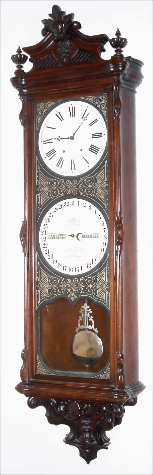 Ithaca Calendar Clock Co., Ithaca, New York, "Regulator No. 1". 8 day, time and perpetual calendar, center sweep seconds, two weight driven movement in a walnut case with engraved and highlighted dial mask and papered metal dials, s#20, dated December of 1891 — Antique Clocks Price Guide