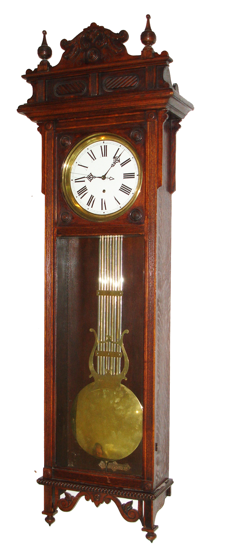 Waterbury Clock Co., Waterbury, Conn., "Regulator No. 60" wall clock, 8 day, time only, weight driven movement with deadbeat anchor escapement, sweep seconds and gridiron pendulum in an oak case with white enamel dial signed at bottom "MANUFACTURED BY WATERBURY CLOCK CO. U.S.A." and Waterbury G-clef hands, c1903 — Antique Clocks Price Guide