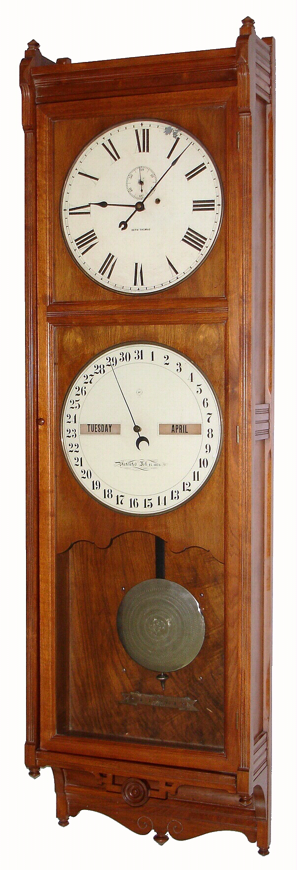 Seth Thomas Clock Co., Thomaston, Conn., "Office Calendar No. 9" wall clock, 8 day, time and perpetual calendar, single wafer weight driven movement with damascened pendulum bob in a walnut case with painted metal dials, c1885 — Antique Clocks Price Guide