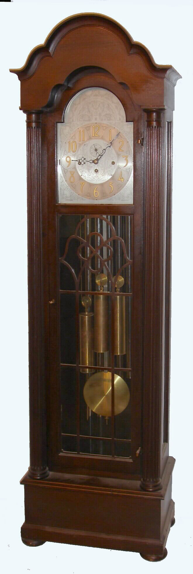 Herschede Clock Co., Cincinnati, Ohio, "Pattern No. 310", 5 tube hall clock, 8 day, time, strike and chime, three weight driven movement playing Westminster tune in a mahogany case with reeded full columns on sides, bun feet and three glass trunk. The silvered dial has applied brass Arabic numerals, and engraving, c1920 — Antique Clocks Price Guide