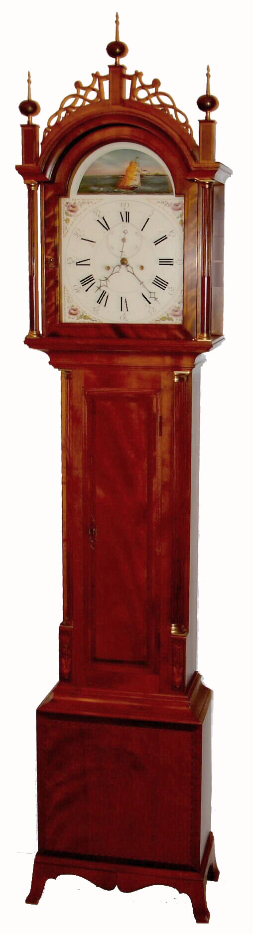 Elmer O. Stennes, Weymouth, Mass., "Rocking Ship" tall clock, 8 day, time and strike, weight driven movement in a cherry case with inlaid decoration of potted plant flanking lower trunk door, reeded corner columns with walnut inlay flanking both trunk and hood and Roxbury fretwork on hood with painted metal dial, c1968 — Antique Clocks Price Guide
