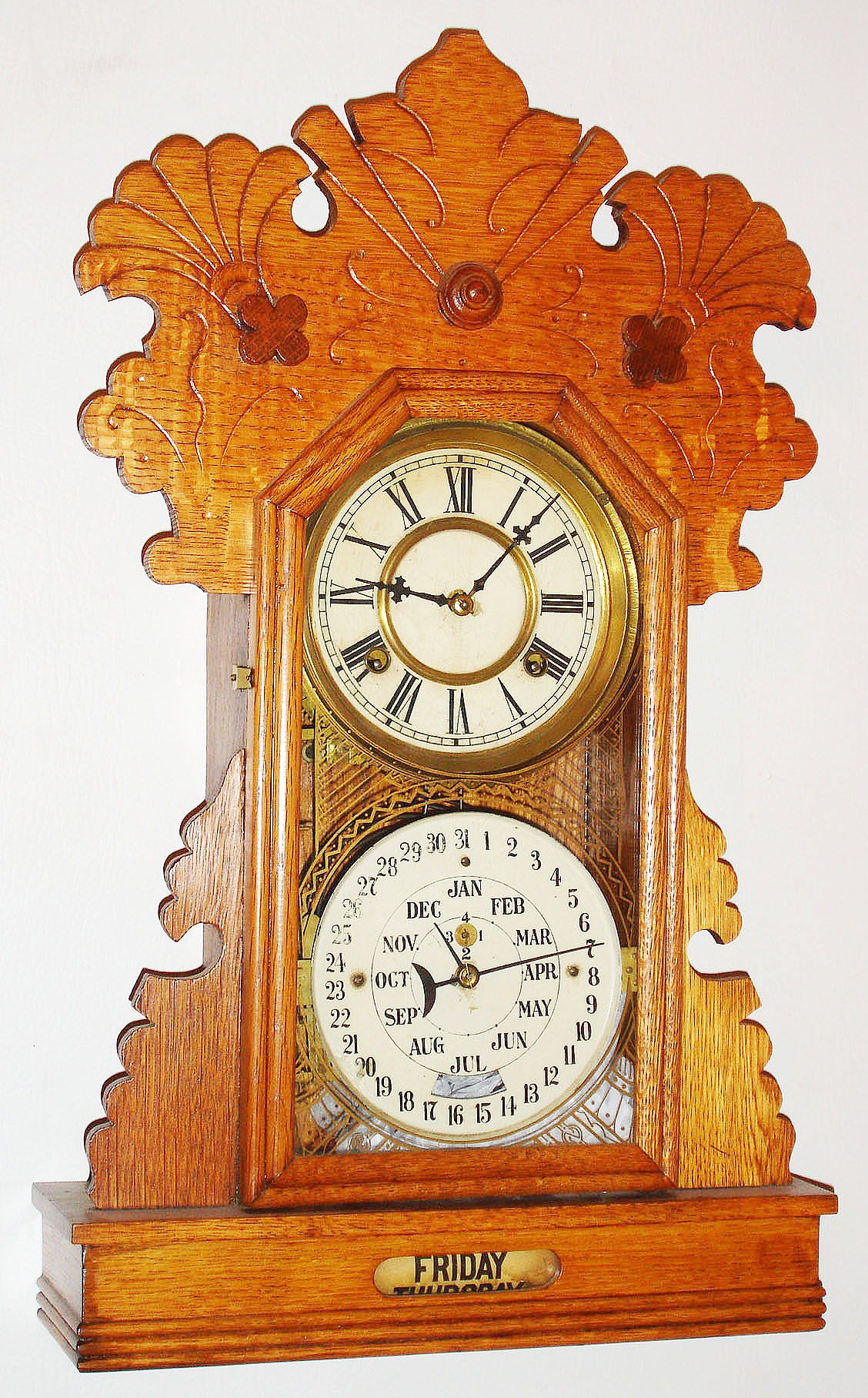 Charles W. Feishtinger, Fritztown, Pa, 8 day, time and strike calendar shelf clock.  These clocks were manufactured by Waterbury Clock Co. for him.  This model with modifications to the base is the "Hebron". — Antique Clocks Price Guide