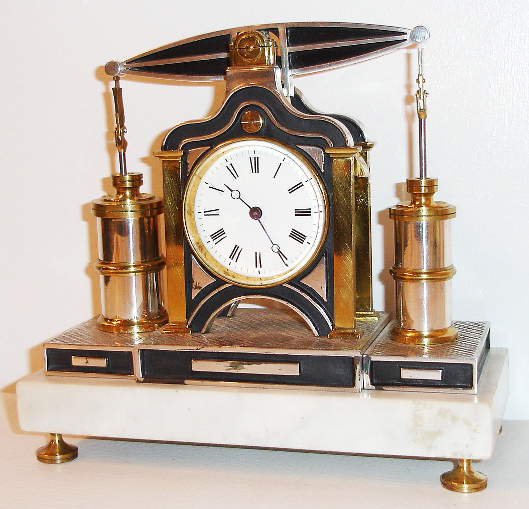 France, small industrial beam engine desk clock by Guilmet, eight day time only movement, back plate marked Medialle D'Or GLT Paris, white enamel Roman numeral dial with blued steel Breguet style hands, the engine with bright and patinated silver and gold surfaces, mounted on a white marble base with turned brass feet, c1880 — Antique Clocks Price Guide