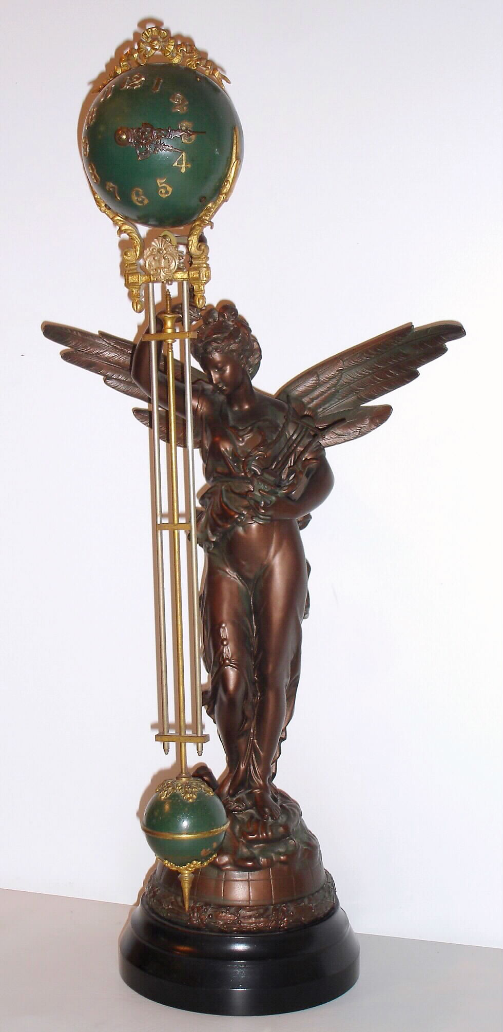 Ansonia Clock Co., New York, NY, "GLORIA" swing clock, time only, the arm moving slowly without apparent impulse, c1900 — Antique Clocks Price Guide