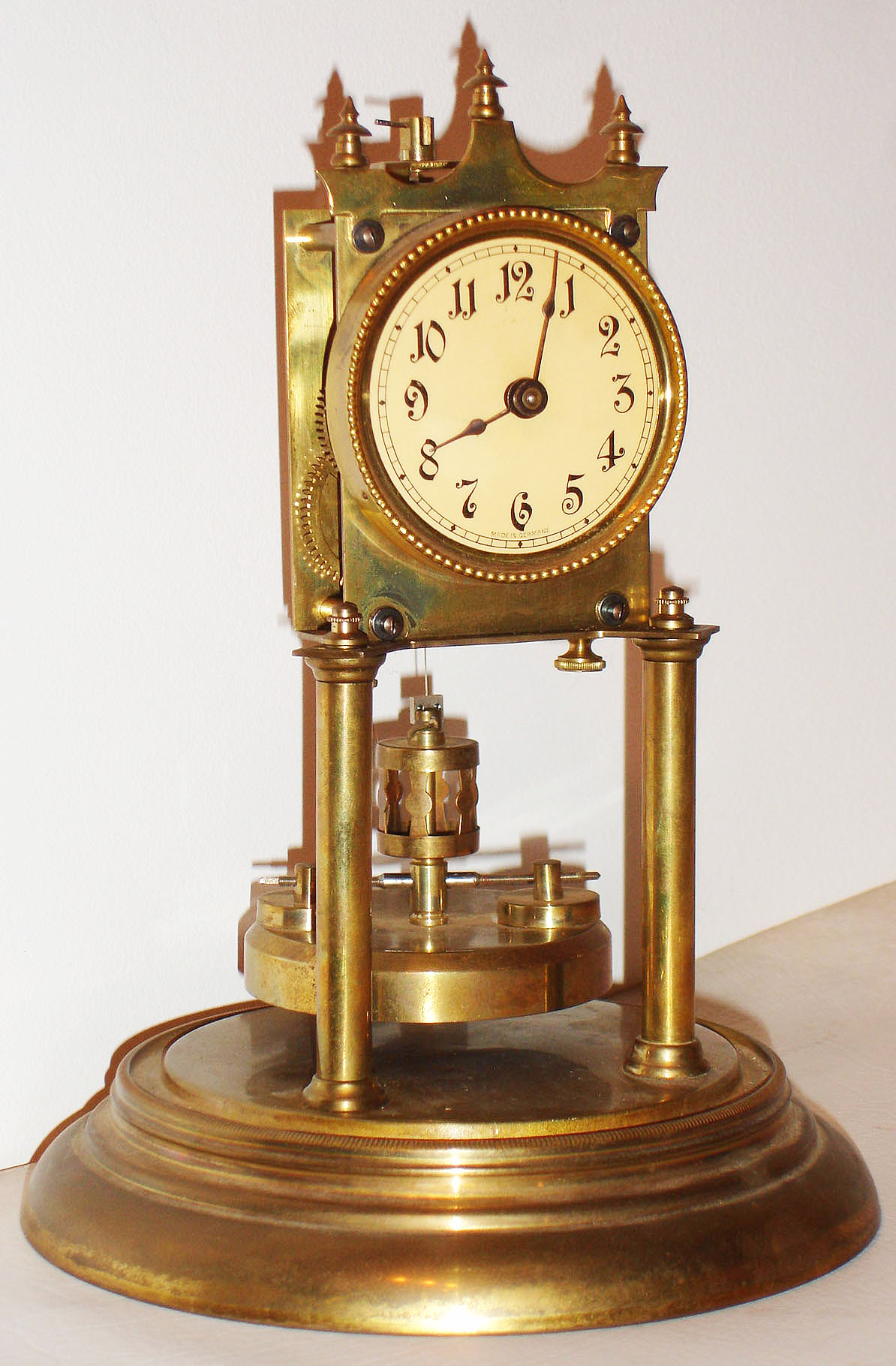 German brass 400 day disk pendulum mantel clock with glass dome, c1910 — Antique Clocks Price Guide