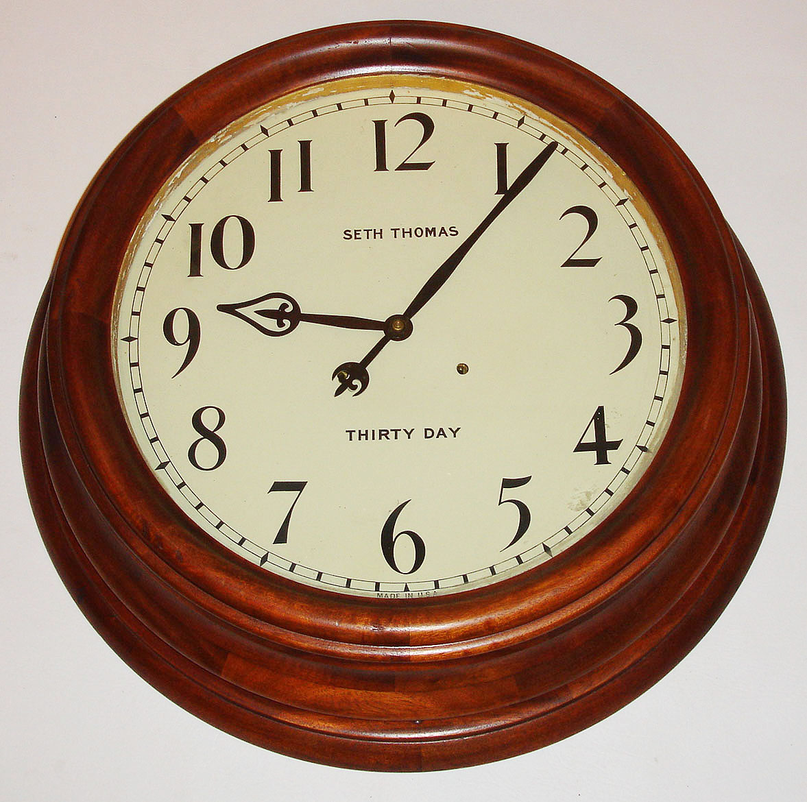 Seth Thomas Clock Co., Thomaston, Conn., "Gallery 18 Inch" wall clock, 30 day, time only, double spring driven movement in a mahogany case with painted metal dial, c1913 — Antique Clocks Price Guide
