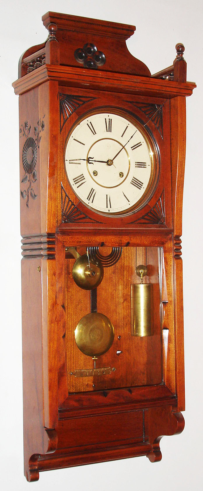 Seth Thomas Clock Co., Thomaston, Conn., "Flora" wall clock, 8 day, time and strike, weight driven movement in a cherry case with painted metal dial and damascene pendulum bob, c1883 — Antique Clocks Price Guide