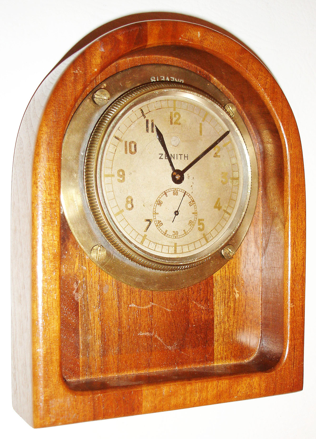 Zenith, Le Locle, Switzerland, 9 jewels, rim wind and set, spotted damascene gilt plate movement, with lever escapement and cut bimetallic balance in a nickel plated brass case, mounted in a mahogany stand, and Arabic numeral, silvered brass dial, black painted brass hands, serial #1213, c1920 — Antique Clocks Price Guide