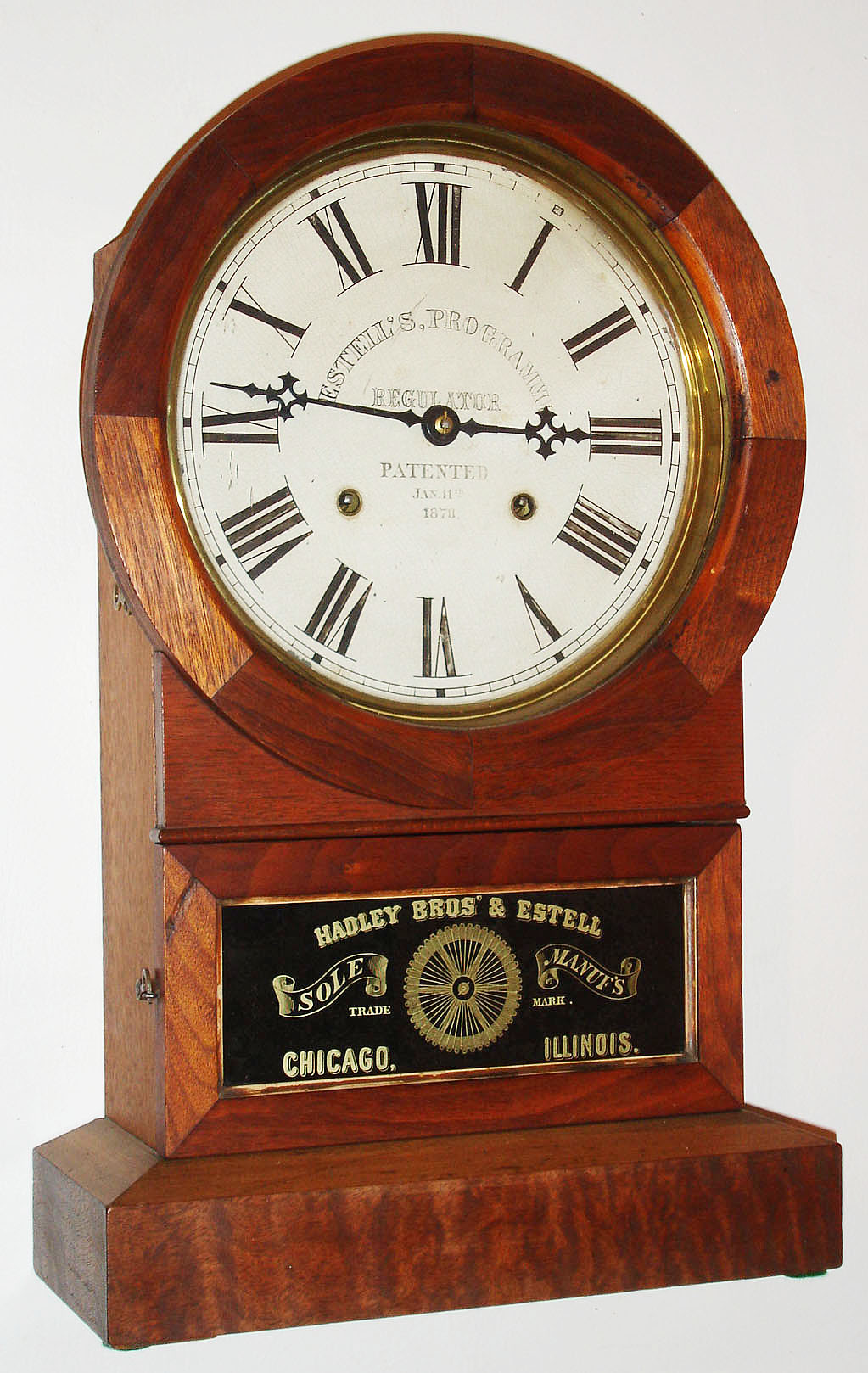 Hadley Bros. and Estell, Chicago, Ill., 8 day, time and strike clock with a complicated arrangement of pins on a wheel in the back of the movement to allow timing of many events.  It was invented by Samuel F. Estell.  A very unusual clock, c1874. — Antique Clocks Price Guide