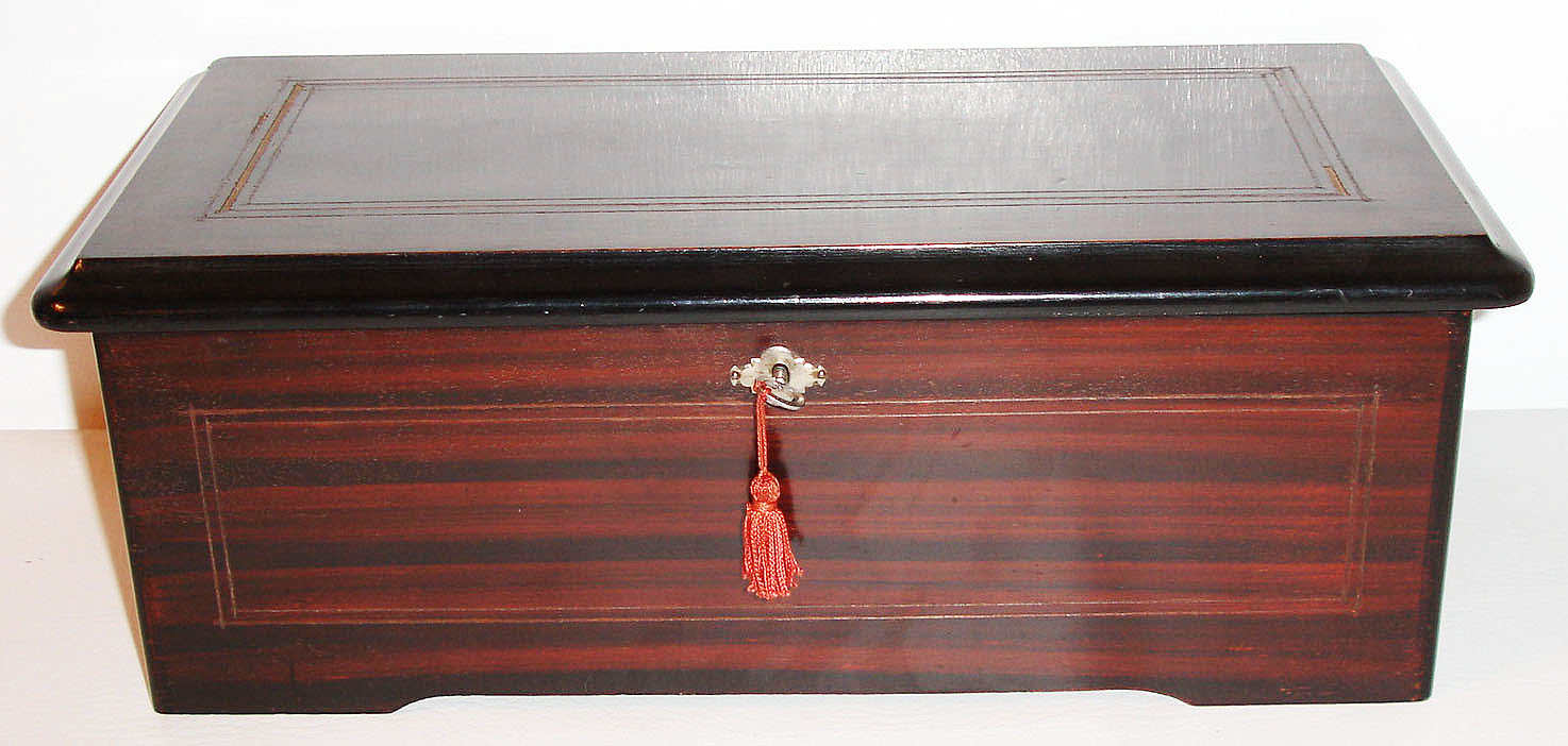 Switzerland, small eight tune cylinder music box, 5 inch cylinder with 35 tooth comb, glazed cover over movement, inside of lid with lithographed card in color featuring musical putti, and the tunes written in ink, the box with painted rosewood graining, and line inlays of unknown material, together with a small lot of ephemera, mostly rewards of merit, and two small papers with the names of the various tunes c1890 — Antique Clocks Price Guide