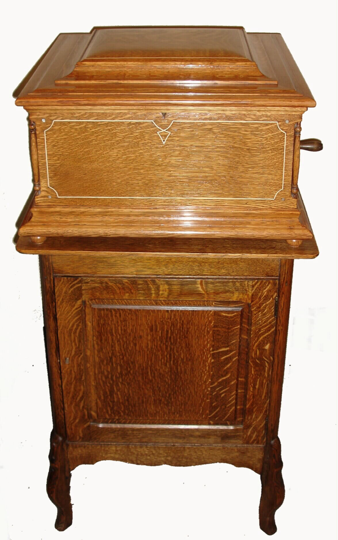 Regina Music Box Co., Rahway and Jersey City, N.J., Style No.11, table top 15 Ohm inch, double comb, disc playing music box, quarter sawn oak case with mother of pearl dot and white line inlays, stepped molded top, and molded base supported on turned ball feet, inside of lid with orig label from C. J. Heppe and Son, Philadelphia, and Regina label, together with a quarter sawn oak disc storage cabinet with 15+ discs, bedplate serial #55312, c1900 — Antique Clocks Price Guide