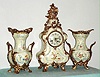 German, Lenzkirch, 3-piece mantel set of porcelain with ormolu adornments, and with quality round movement with porcelain dial and fancy brass hands, the case and side pieces with floral trim, c1875