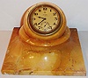 Switzerland, for Greenleaf and Crosby, Zenith rim wind and set eight day time only desk clock in marble case, the gilt movement contained in a marble sphere, the sphere resting in a square marble base allowing the clock to be tilted to any angle, matte gilt Arabic numeral dial marked 8 Days Greenleaf and Crosby Co. Florida, plum colored hands, am/ pm indicator, c1930
