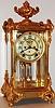 Ansonia Clock Co., New York, NY, "Marquis" model crystal regulator, eight day time and strike movement, open escapement, simulated mercury pendulum,  white enamel Arabic numeral dial, blued steel hands, gilt brass case with gilt spelter ornament, beveled glass panels c1900