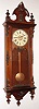 Wm. L. Gilbert Clock Co., Winsted, Conn., "Regulator No. 3" wall clock, 8 day, time only, weight driven movement in a rosewood case with applied castings and turned finials and paper dial, c1870